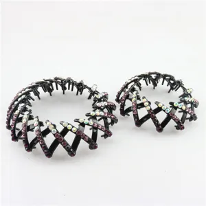 Detail view of sparkly rhinestone bird nest hair clips, elegant black bun maker for women.