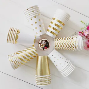 Gold foil paper cups detail showing various stylish patterns arranged in a creative flat lay design.