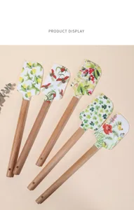 Silicone spatula detail showing various botanical patterns and wooden handle for baking.