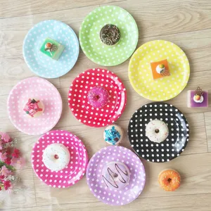 Detailed view of colorful polka dot paper plates set, cute disposable cake dishes for party.