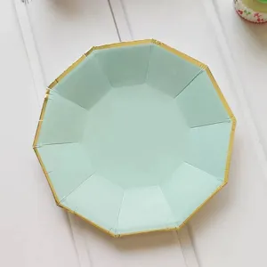 Mint green decagonal paper plate with elegant gold foil rim, detailed view of party tableware close up.