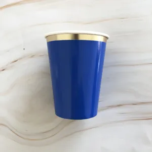 Close-up view of the solid blue disposable paper cup featuring an elegant metallic gold rim.
