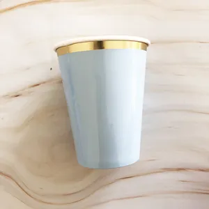 Light blue disposable paper cup featuring a classy gold rim detail for elegant party use.