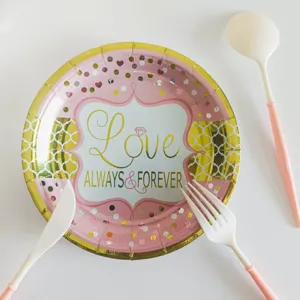 Disposable pink gold party paper plates and cutlery set for birthday celebrations and events