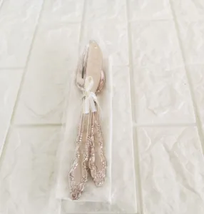 Rose gold vintage embossed disposable cutlery set with ribbon for party table decoration.