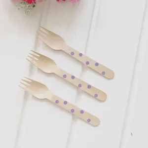 Wooden polka dot disposable forks detailed view, ideal for kids birthday party cake and desserts.