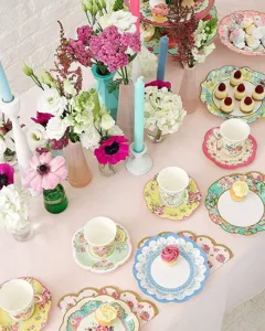 Detailed shot of vintage floral disposable paper plates and cups for elegant wedding party table decor.