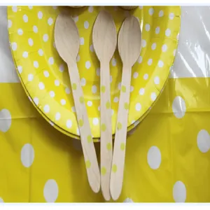 Disposable wooden spoons with yellow polka dots, perfect for cakes, desserts, and takeout food use.