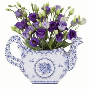 Teapot shaped vase with purple eustoma flowers for afternoon tea party table decor.