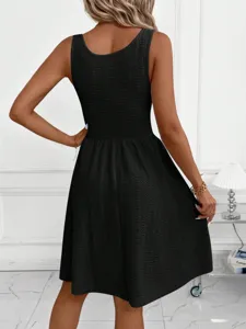 Black sleeveless pleated casual summer dress back view showing elegant silhouette and flowy hem.