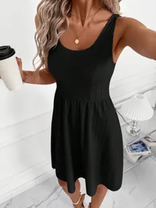 Close-up detail of the black sleeveless textured casual tank dress worn by the model in scene.