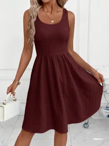 Close-up detail of women's solid textured sleeveless pleated casual dress in elegant style.