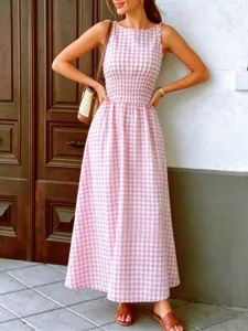 Detailed view of the pink gingham sleeveless maxi dress featuring a smocked waist and tie straps.