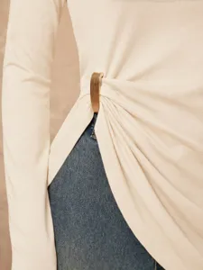 Detailed view of women slim fit long sleeve t-shirt with chic metal buckle side slit.