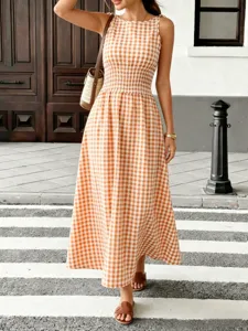 Detailed view of the elegant orange gingham midi dress featuring a comfortable smocked waist.