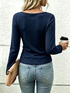 Detail view of elegant solid navy blue long sleeve top, slim fit design, back view showcasing.
