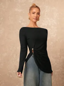 Detailed view of the stylish women's long sleeve black top featuring an irregular metal buckle.