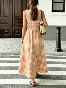 Back view detail of a chic brown gingham sleeveless maxi dress with smocked waist.