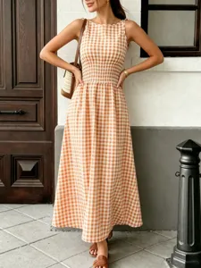 Detailed view of the orange and white gingham sleeveless maxi dress featuring a smocked waist.