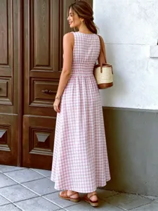 Pink gingham sleeveless maxi dress, smocked waist detail, stylish outdoor summer apparel.