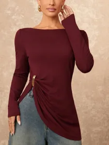 Detailed view of the burgundy long sleeve top with stylish metal buckle and side slit.