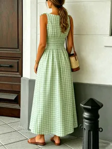 Green gingham smocked maxi dress featuring a chic crew neck and sleeveless design for summer.