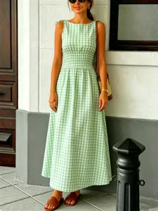 Elegant green gingham sleeveless midi dress with smocked waist and tie shoulder straps for summer.