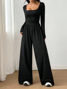Detailed view of the black square neck long sleeve ruched waist wide leg jumpsuit outfit.