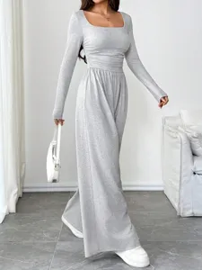 Grey square neck long sleeve wide leg jumpsuit detail showcasing elegant waist cinching fit.