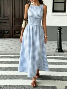 Blue and white gingham midi dress detail shot, featuring smocked waist and elegant sleeveless design.