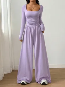 Detail view of the elegant light purple square neck long sleeve wide leg jumpsuit with ruched waist.