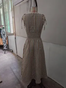 Brown and white checkered summer sleeveless midi dress with smocked waist and tie shoulders.
