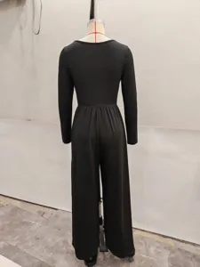Black long sleeve wide leg jumpsuit back view detail, minimalist casual solid color outfit.