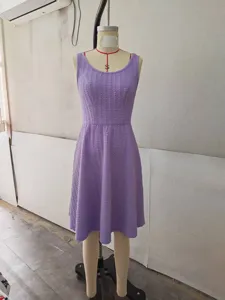 Detailed view of the sleeveless textured purple dress on mannequin, showcasing fabric.
