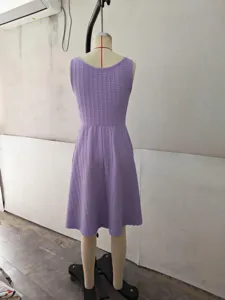 Detail view of the purple textured sleeveless casual dress displayed on a mannequin in workshop.
