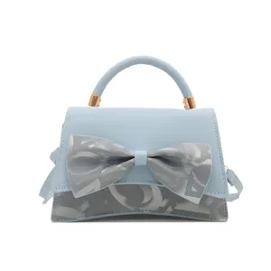 Light blue top handle shoulder bag for women, stylish casual crossbody bag with bow accent.