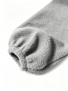 Close-up detailed view of soft gray sherpa fleece sleeve cuff texture winter apparel.