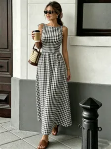 Chic sleeveless black and white gingham maxi dress with smocked waist for summer.