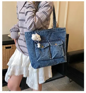 Large capacity denim tote bag with front pockets and cute cloud pendant for daily casual use.