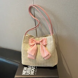 Woven straw shoulder bag with pink bow, large capacity casual tote bag for women daily use.