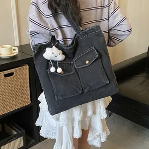 Casual denim tote bag with front pockets large capacity shoulder handbag for daily student use.