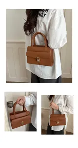 Vista dettagliata dell'elegante borsa in pelle marrone con finitura e chiusura in metallo.