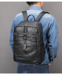 Back view detail of a black genuine leather backpack with large capacity and smooth zippers.