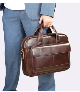 Closeup of the brown genuine leather briefcase handle and textured front pocket detail.