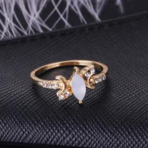 Detailed closeup of a gold-toned crescent moon ring featuring a marquise opal and sparkling rhinestones.