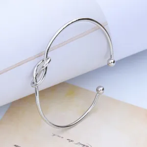 Detailed close-up of the elegant silver open cuff bracelet featuring an 8-knot design.