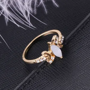 Vintage gold plated ring featuring a marquise white opal and sparkling cubic zirconia accents.