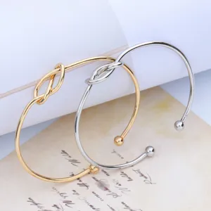Minimalist knot open alloy bangle detail shot, stylish adjustable metal bracelet for daily wear.