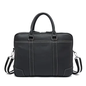 Black leather business laptop bag detail showing white stitching and striped shoulder strap.