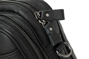 Close-up detail of black leather men business bag zipper hardware and texture craftsmanship.